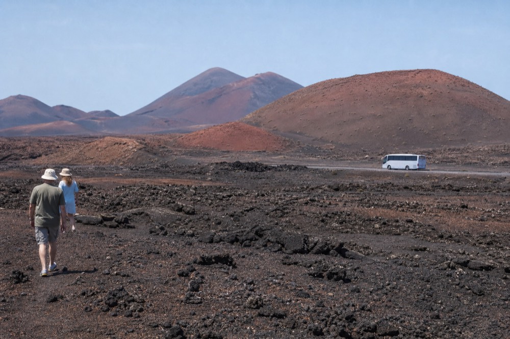 Timanfaya volcanic badlands with rust-red cones and black lava fields