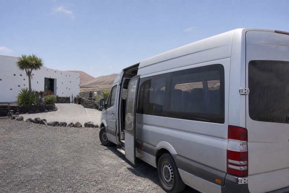 Minibus parked outside a whitewashed bodega