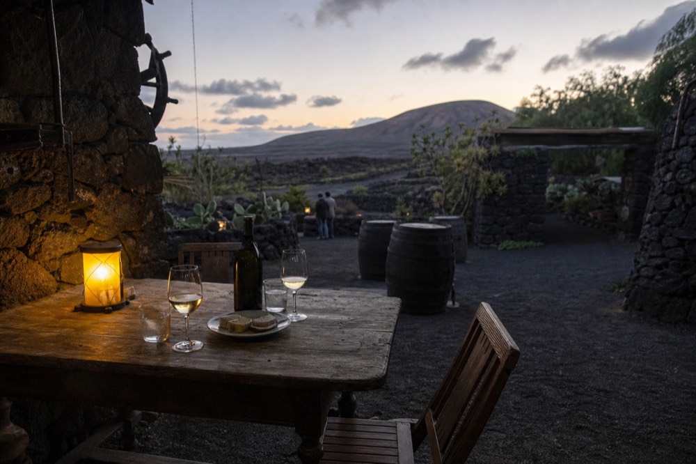 Wine tasting setup inside a bodega with volcanic stone walls
