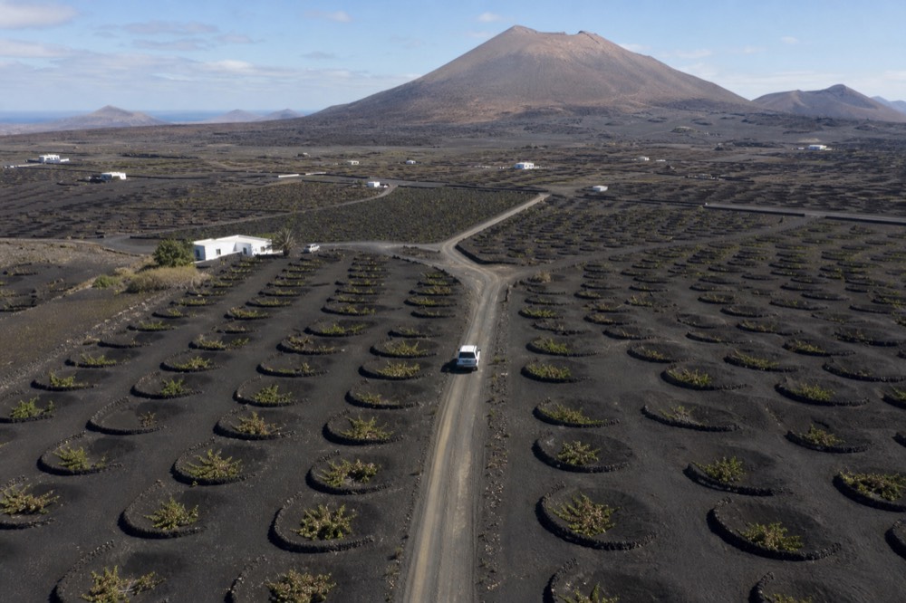 Aerial view of La Geria vineyards with Timanfaya in the distance