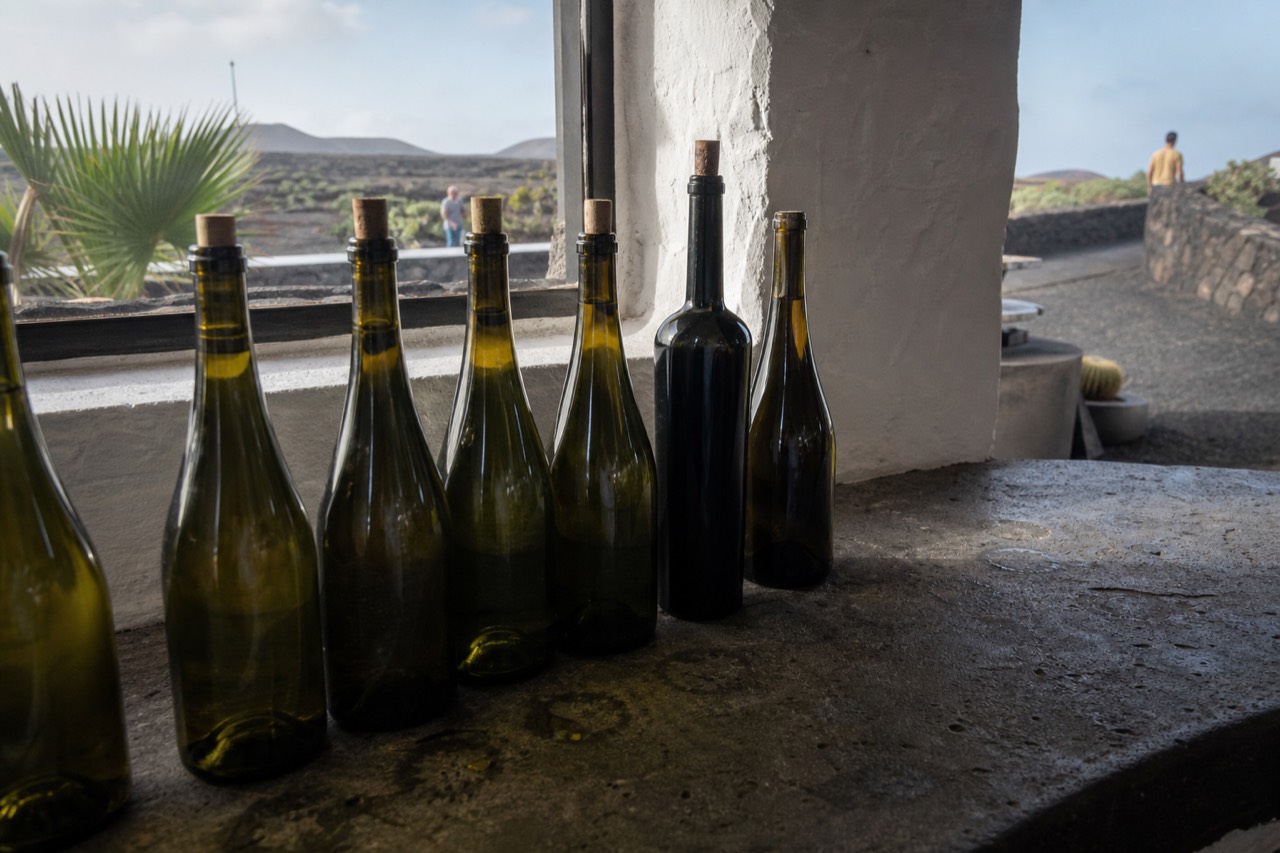 Bottles of Lanzarote malvasía lined on a volcanic stone tasting counter