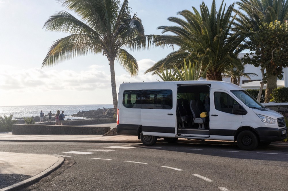 A minibus parked in front of a vineyard