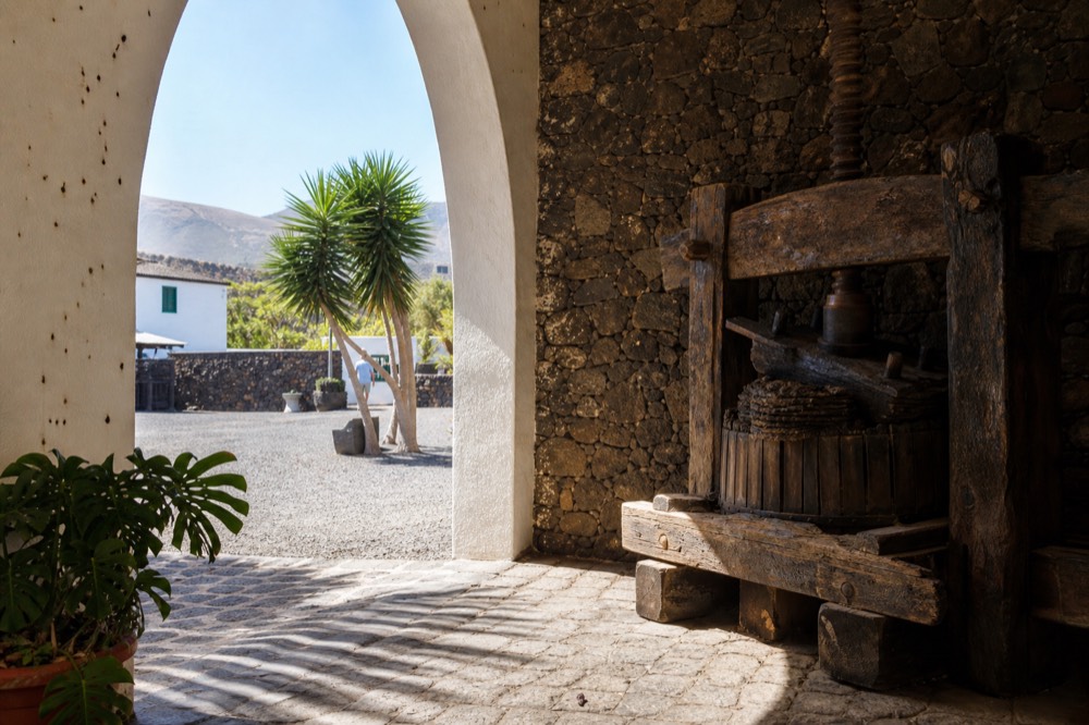 El Grifo's courtyard with old wine press and volcanic stone walls